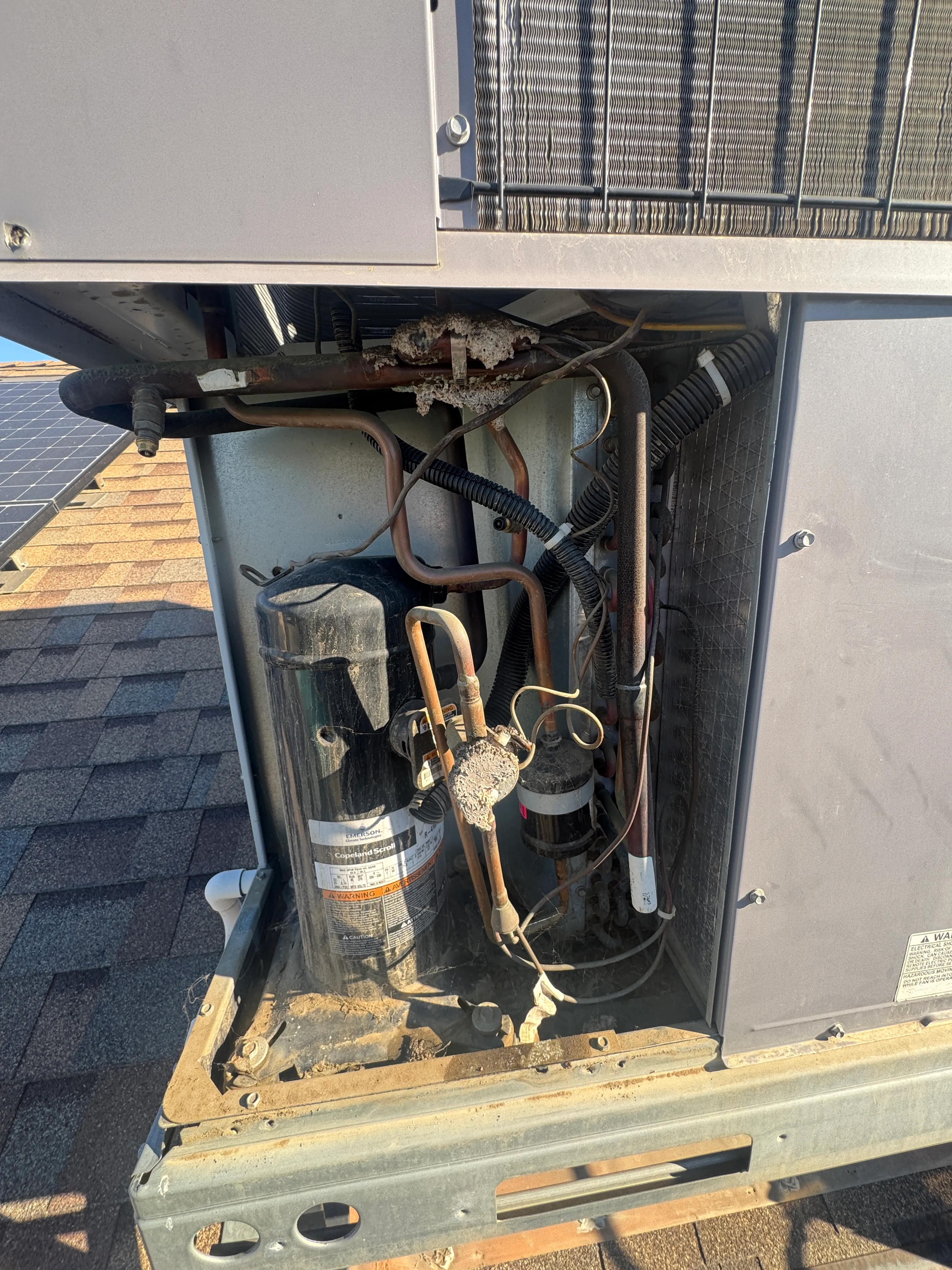 A rooftop package unit open for service on a Bakersfield roof during a Wildflower Climate visit